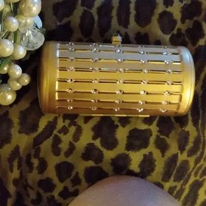 Small lady purse. Brushed gold in color carry with chain or without.